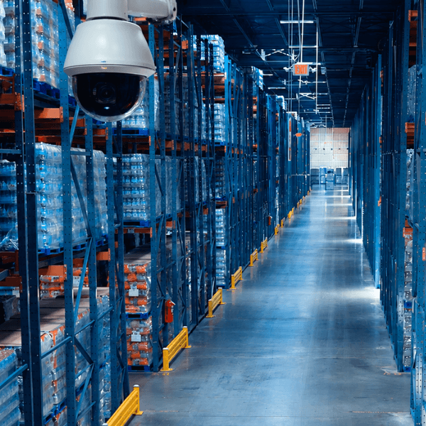 Security camera monitoring of beverage inventory inside a CDS warehouse distribution center with pallet racking and bulk storage.
